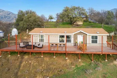 a home with a large deck and a house at 4 Mil to Sequoia NTL Park Private River Access in Three Rivers