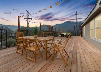 a wooden deck with a wooden table and chairs at 4 Mil to Sequoia NTL Park Private River Access in Three Rivers