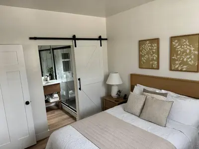 a bedroom with a bed and a bathroom with a mirror at Soleil Luna 2 miles from Sequoia Park Entrance in Three Rivers