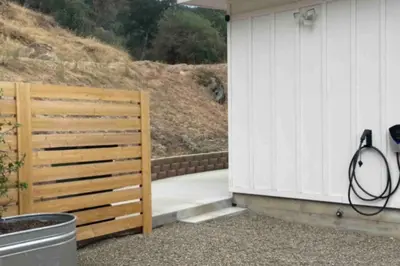 a wooden gate next to a white building at Soleil Luna 2 miles from Sequoia Park Entrance in Three Rivers