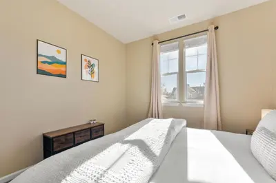 a bedroom with a bed and a window at MidTown Hideaway Fire Pit and King Beds in Reno