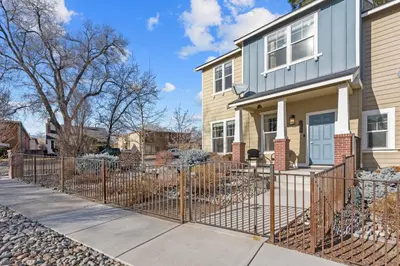 a house with a fence in front of it at MidTown Hideaway Fire Pit and King Beds in Reno