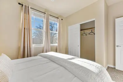 a bedroom with a white bed and a window at MidTown Hideaway Fire Pit and King Beds in Reno