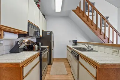 a kitchen with a sink and a refrigerator at Sierra Cabin Condo – Sun Meadows 1 BedroomLoft condo in Kirkwood