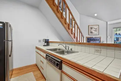 a kitchen with a sink and a refrigerator at Sierra Cabin Condo – Sun Meadows 1 BedroomLoft condo in Kirkwood
