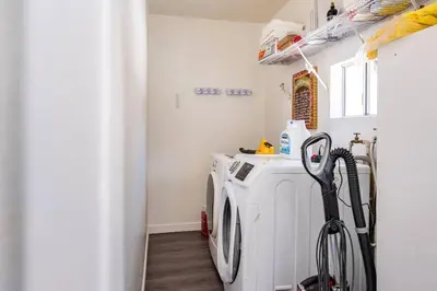a washer and dryer in a laundry room at Modern LakeHouse Sleeps 20 Hot Tub/Games/Fire Pit in Oakhurst