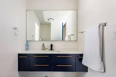a bathroom with a sink and a mirror at Modern LakeHouse Sleeps 20 Hot Tub/Games/Fire Pit in Oakhurst