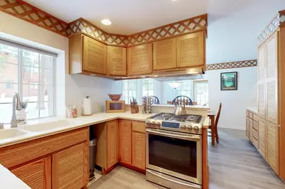 a kitchen with wooden cabinets and a stove at Blue Skies & Bay Bliss in Carnelian Bay