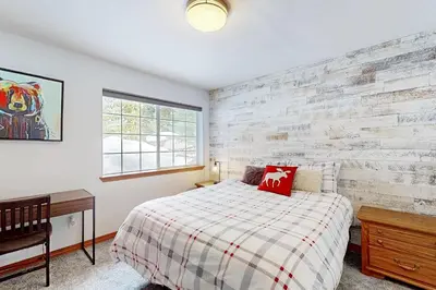 a bedroom with a bed and a brick wall at Blue Skies & Bay Bliss in Carnelian Bay