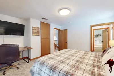 a bedroom with a bed and a desk and a computer at Blue Skies & Bay Bliss in Carnelian Bay
