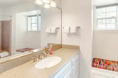 a white bathroom with a sink and a mirror at Blue Skies & Bay Bliss in Carnelian Bay