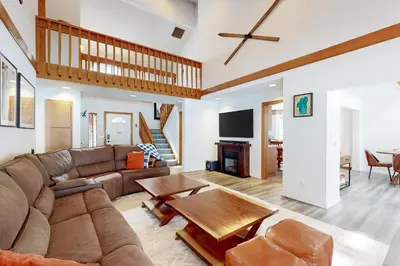 a living room with a couch and a table at Blue Skies & Bay Bliss in Carnelian Bay