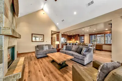 a living room with couches and a fireplace at Sierra Shores Four - Lakefront Vistas in South Lake Tahoe