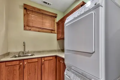 a kitchen with a white refrigerator and a sink at Sierra Shores Four - Lakefront Vistas in South Lake Tahoe