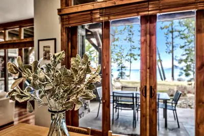 a vase of flowers on a table in a room at Sierra Shores Five - Lakefront Comfort in South Lake Tahoe