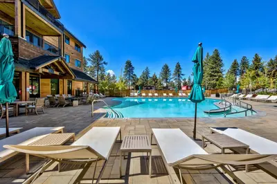 a pool at a hotel with chairs and umbrellas at Zalanta 220 - Heavenly Wow-Pool View in Stateline