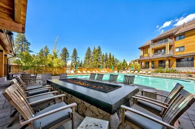 a swimming pool with chairs and a table with a fire pit at Zalanta 220 - Heavenly Wow-Pool View in Stateline