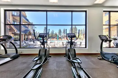 a gym with three elliptical machines in front of a large window at Zalanta 220 - Heavenly Wow-Pool View in Stateline