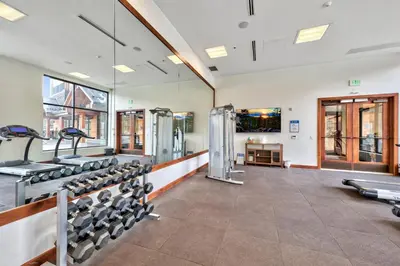a gym with a row of exercise machines at Zalanta 222 – Luxe Stay by Gondola Lake in Stateline