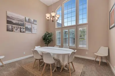 a dining room with a white table and chairs at Stargazing Retreat: fire pit/hot tub near Yosemite in Ahwahnee