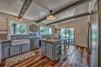 a kitchen with wooden floors and a wooden ceiling at Duckhook at Tahoe in South Lake Tahoe