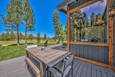 a wooden deck with a table and chairs on a house at Duckhook at Tahoe in South Lake Tahoe