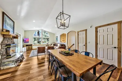 a dining room and living room with a table and a fireplace at Heavenly Retreat in South Lake Tahoe