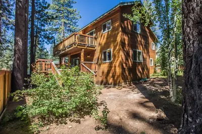 a log home in the woods with a deck at Heavenly Retreat in South Lake Tahoe