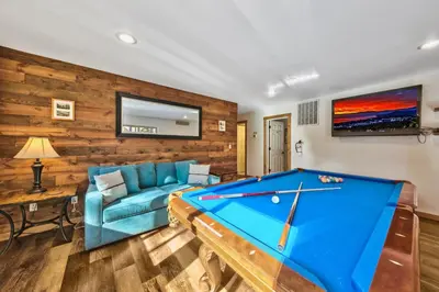 a living room with a pool table and a couch at Heavenly Retreat in South Lake Tahoe