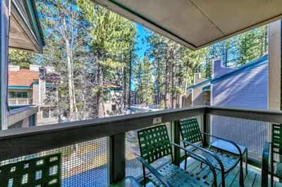 a balcony with two chairs and a table on it at Lakeland Village 410 in South Lake Tahoe