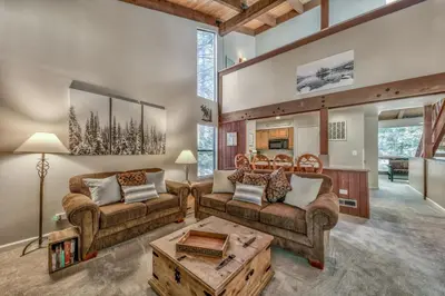 a living room with two couches and a table at Lakeland Village 410 in South Lake Tahoe