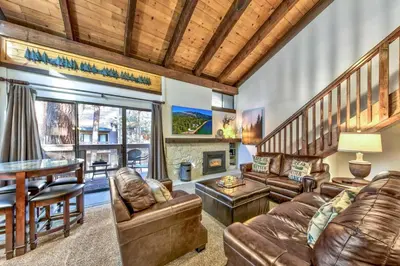 a living room with leather furniture and a fireplace at Lakeland Village 406 - The Lake Escape in South Lake Tahoe