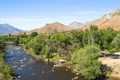 a river with trees and mountains in the background at Brand new Cabins in Kernville