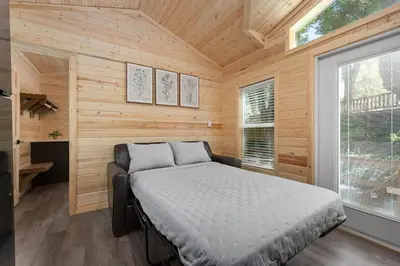 a bedroom with a bed in a wooden cabin at Brandnew cabin in Kernville