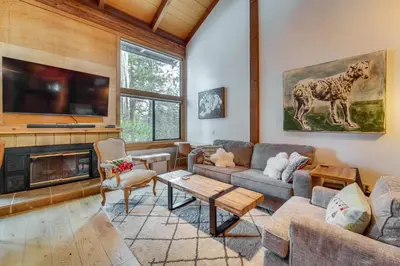 a living room with a couch and a tv at Northstar Resort Condo with Hot Tub, Shuttle Access! in Truckee