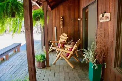 two chairs sitting on the porch of a house at *Pinecone Hollow*Hot Tub & Game Room, Families in Arnold