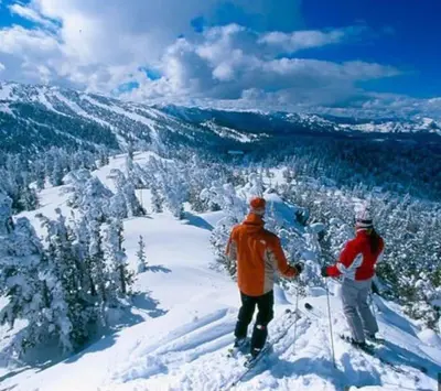 two people on skis on top of a mountain at Cedar Oasis - Pet Friendly Cabin w Fireplace, Games and Wifi - 5 min to Big Trees in Arnold