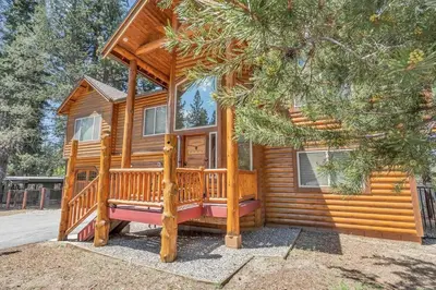 a cabin in the woods with a large deck at 1603 Bel Aire Circle home in South Lake Tahoe