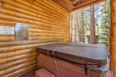 a wooden cabin with a trunk in the side of it at 1603 Bel Aire Circle home in South Lake Tahoe