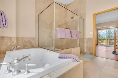 a large bathroom with a tub and a shower at 1603 Bel Aire Circle home in South Lake Tahoe