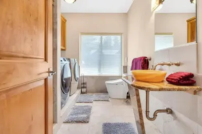 a bathroom with a sink and a washing machine at 1603 Bel Aire Circle home in South Lake Tahoe