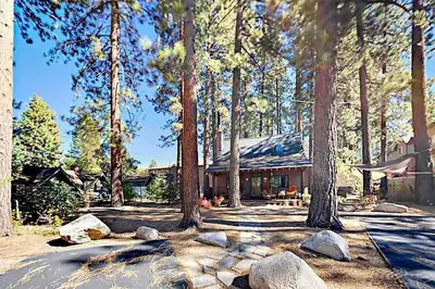 a house with trees and rocks in front of it at 3988 Manzanita Avenue cabin in South Lake Tahoe