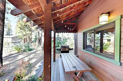 a wooden bench on the side of a house at 3988 Manzanita Avenue cabin in South Lake Tahoe