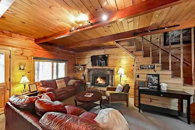 a living room with a couch and a fireplace at 3988 Manzanita Avenue cabin in South Lake Tahoe