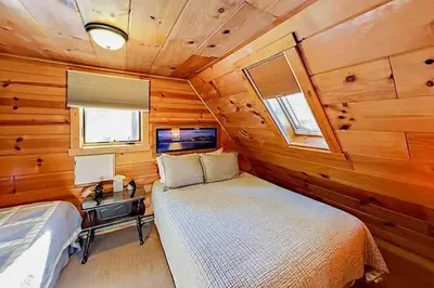 a bedroom in a log cabin with a bed and a desk at 3988 Manzanita Avenue cabin in South Lake Tahoe