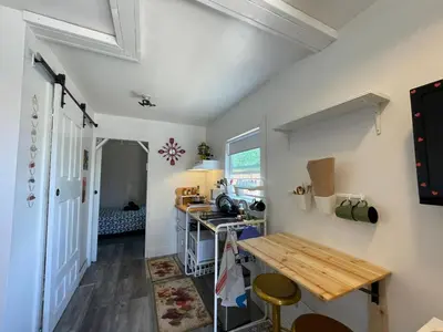 a small kitchen with a table and a counter at Petite Guesthouse with Kitchenette and Private Bathroom in Lake Isabella