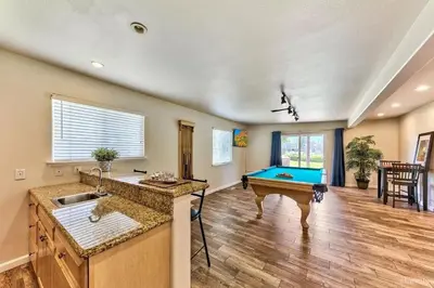 a kitchen with a pool table in the middle of a room at 1759 Venice Drive home in Tahoe Keys