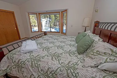 a bedroom with a large bed with towels on it at 2293 Marshall Trail home in South Lake Tahoe