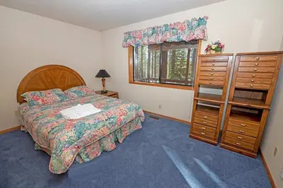 a bedroom with a bed and a dresser and a window at 2293 Marshall Trail home in South Lake Tahoe