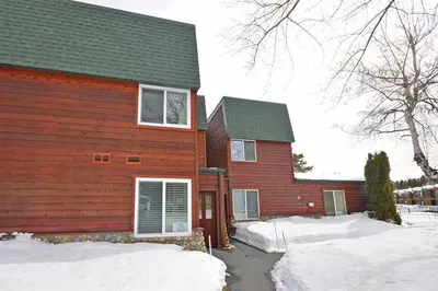 a red house with snow in front of it at 405 Ala Wai Blvd, 180 condo in South Lake Tahoe